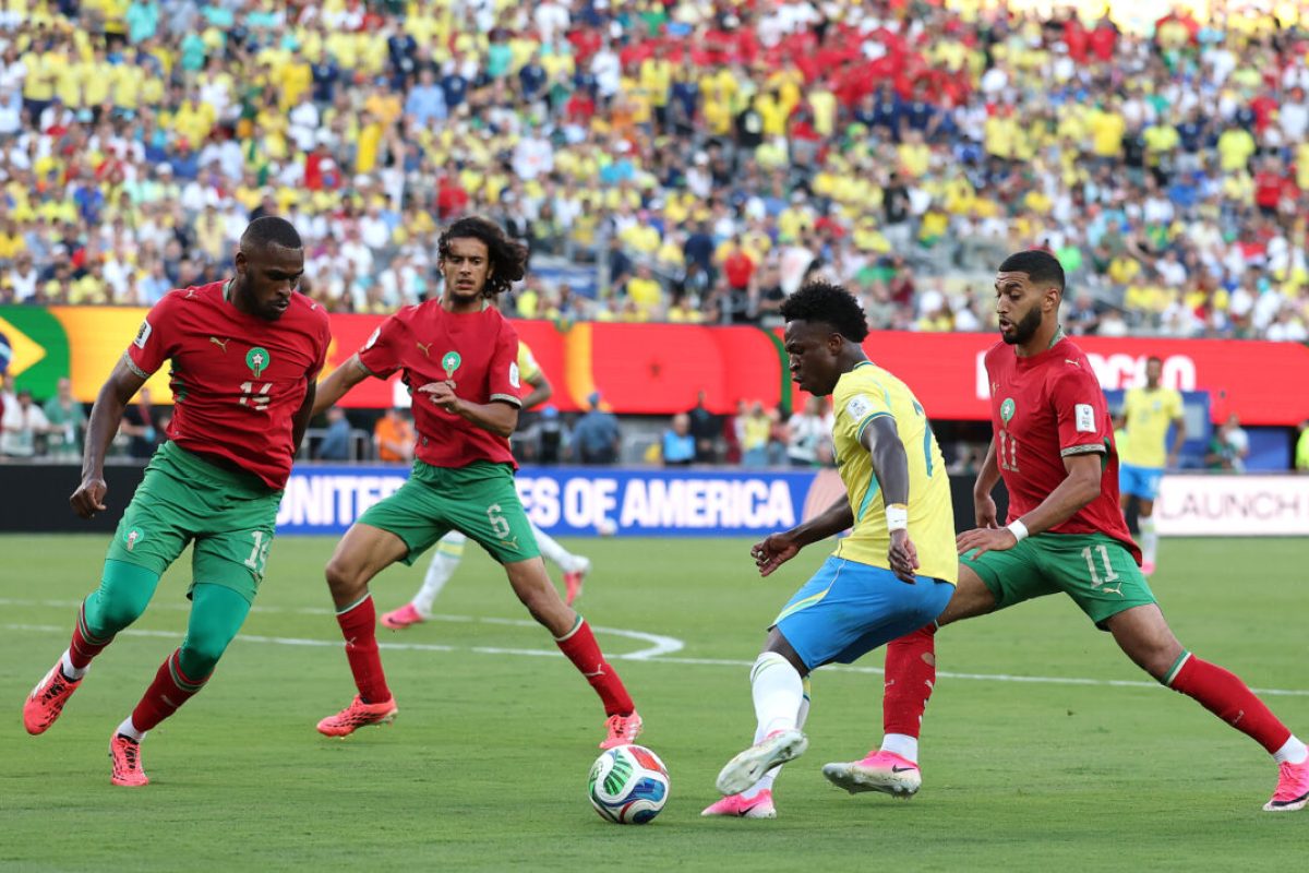 EAST RUTHERFORD, NEW JERSEY - JUNE 13: Vinicius Junior #7 of Brazil controls the ball under pressure from Issa Diop #14, Ayyoub Bouaddi #6 and Ismael Saibari #11 of Morocco during the FIFA World Cup 2026 Group C match between Brazil and Morocco at New York New Jersey Stadium on June 13, 2026 in East Rutherford, New Jersey. (Photo by Darrian Traynor/Getty Images)